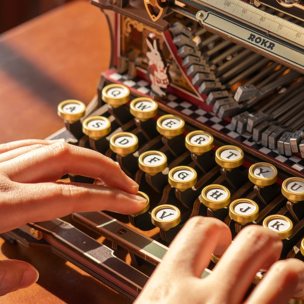 Hands pressing the round keys of the ROKR mechanical typewriter — LK703Ce